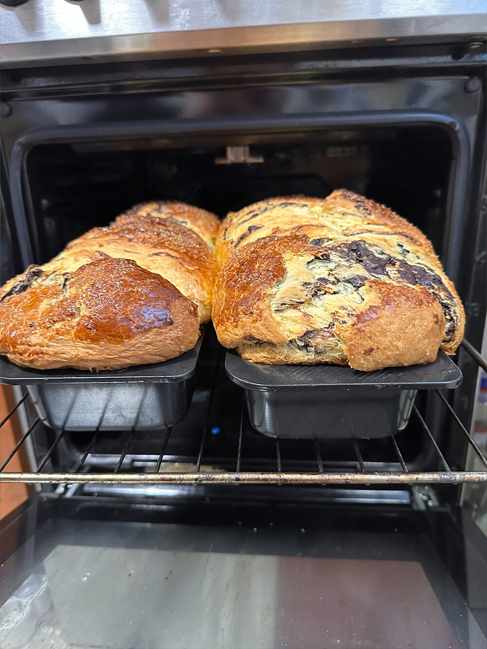 Two homemade cozonac loaves fresh out of the oven